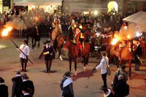 Escalade celebrations in medieval costumes, on the horses with torches.